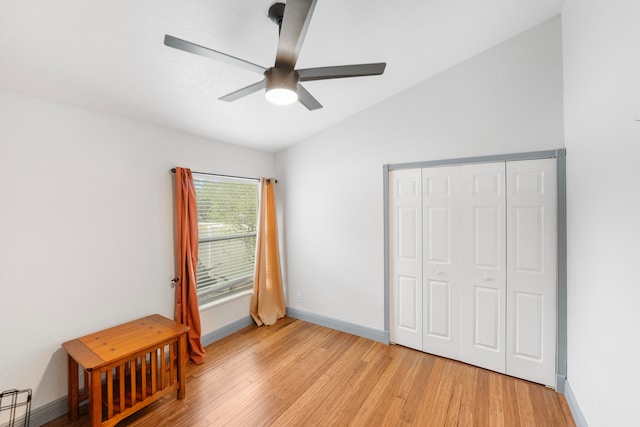 bedroom with vaulted ceiling, light hardwood / wood-style flooring, a closet, and ceiling fan