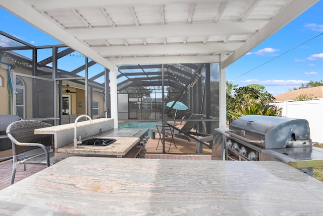 view of patio featuring sink, a grill, and a lanai