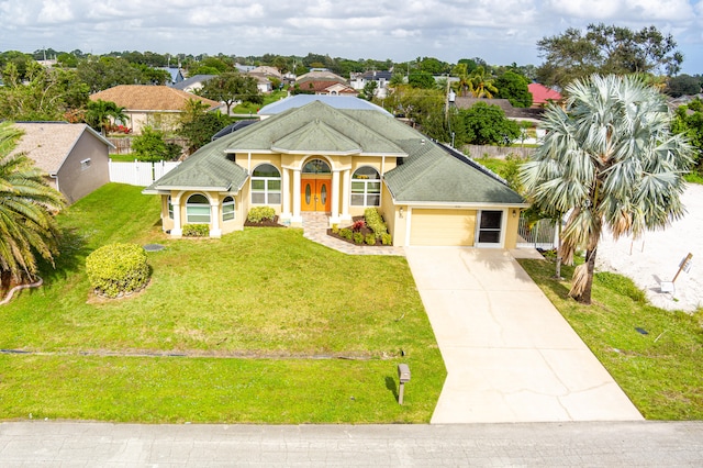 view of front of house with a front lawn and a garage