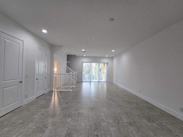 tiled spare room featuring stairway, baseboards, and recessed lighting