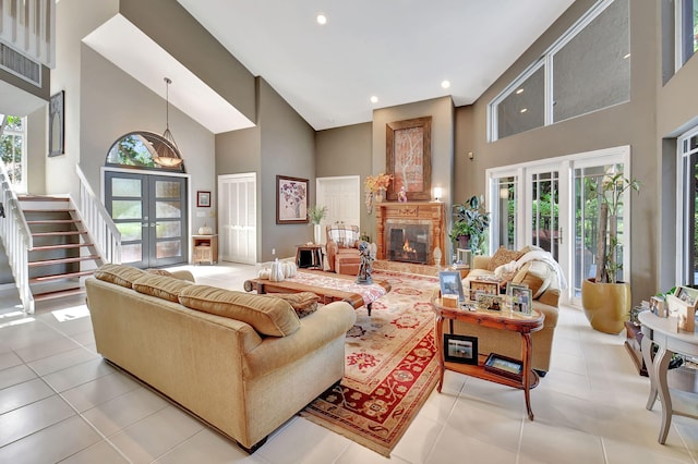 tiled living room with french doors and high vaulted ceiling