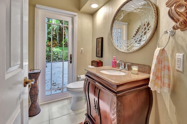 bathroom featuring tile patterned flooring, vanity, and toilet