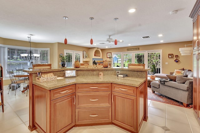 kitchen featuring light stone countertops, french doors, hanging light fixtures, light tile patterned floors, and ceiling fan with notable chandelier