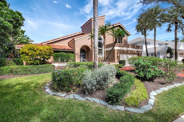 mediterranean / spanish-style house with a garage and a front yard