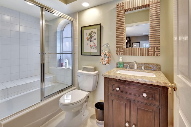 full bathroom with combined bath / shower with glass door, vanity, and toilet