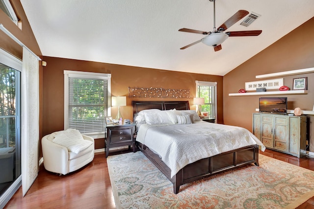 bedroom with ceiling fan, vaulted ceiling, and hardwood / wood-style flooring