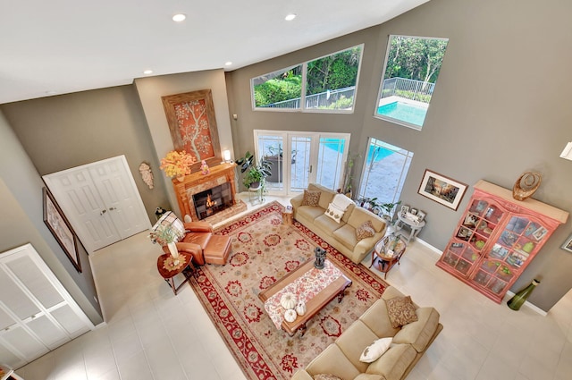 living room featuring a high ceiling and a healthy amount of sunlight