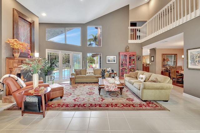 tiled living room featuring french doors and a high ceiling