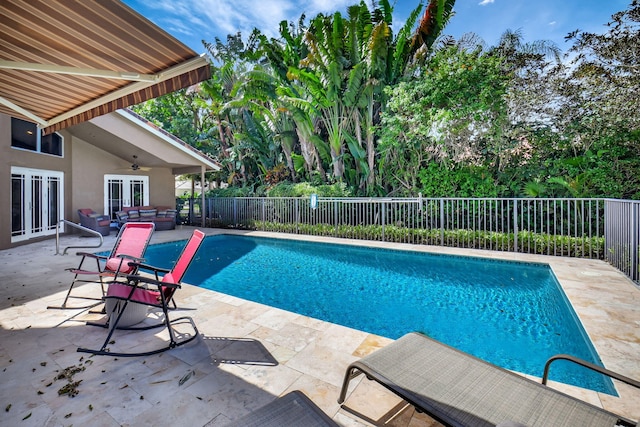 view of pool featuring a patio area and french doors