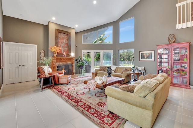 living room featuring high vaulted ceiling and light tile patterned flooring