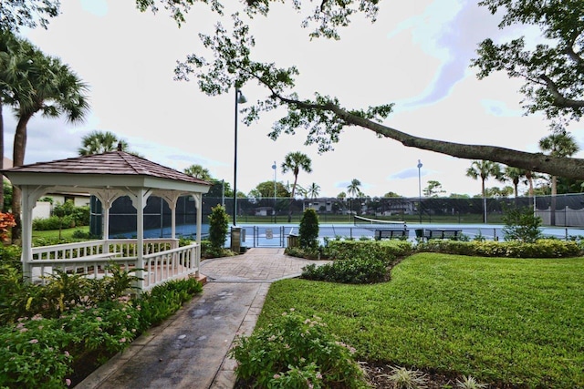 view of home's community with a gazebo, a yard, and tennis court