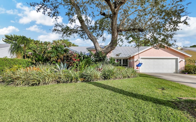 view of front of property with a front yard and a garage