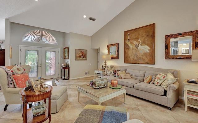 tiled living room featuring french doors and high vaulted ceiling