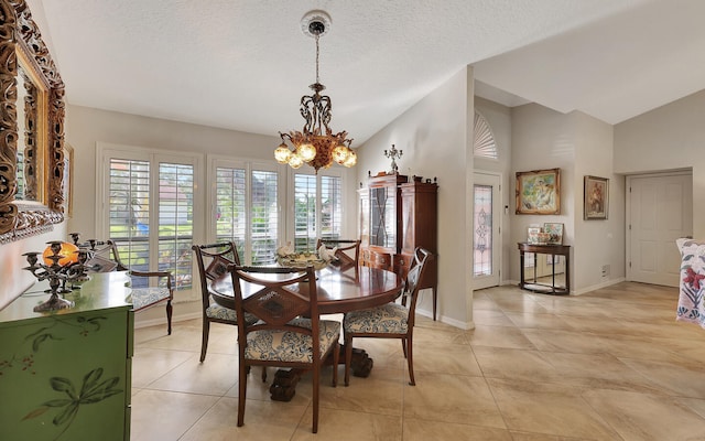 tiled dining space featuring a chandelier, a textured ceiling, and high vaulted ceiling