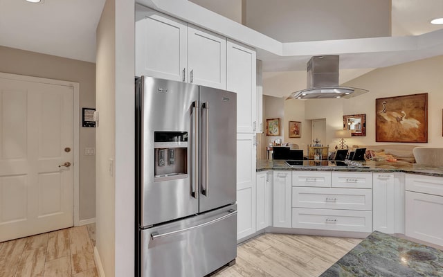 kitchen with dark stone countertops, stainless steel refrigerator with ice dispenser, white cabinets, and light hardwood / wood-style floors