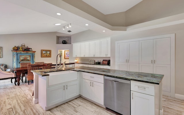 kitchen featuring lofted ceiling, white cabinetry, dishwasher, and light wood-type flooring