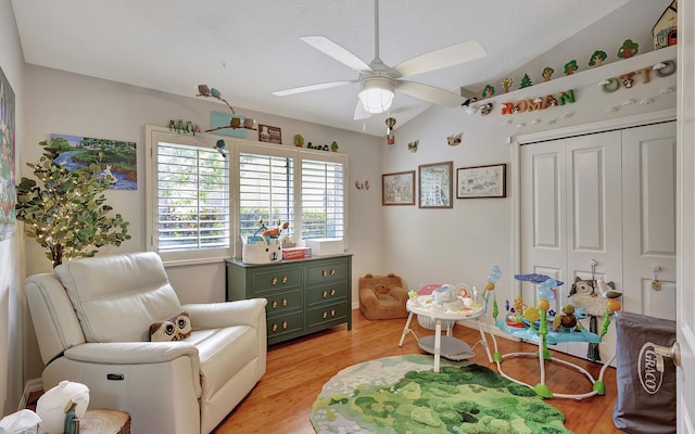 sitting room with light hardwood / wood-style floors, lofted ceiling, and ceiling fan