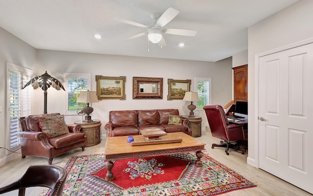 living room featuring ceiling fan and light hardwood / wood-style flooring