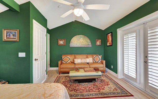 living room with light hardwood / wood-style floors, lofted ceiling, and ceiling fan