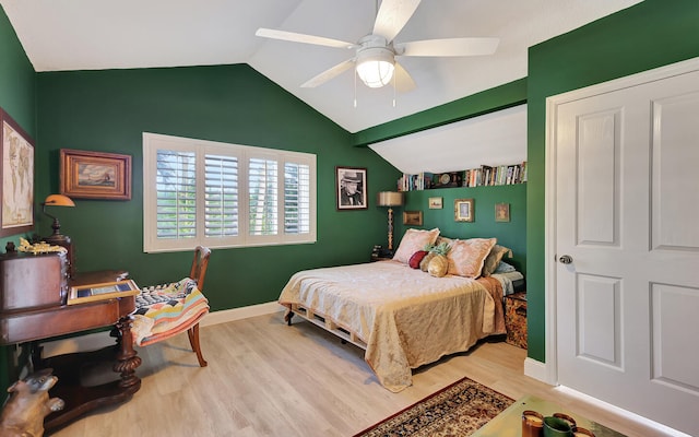 bedroom with ceiling fan, vaulted ceiling, and light hardwood / wood-style floors