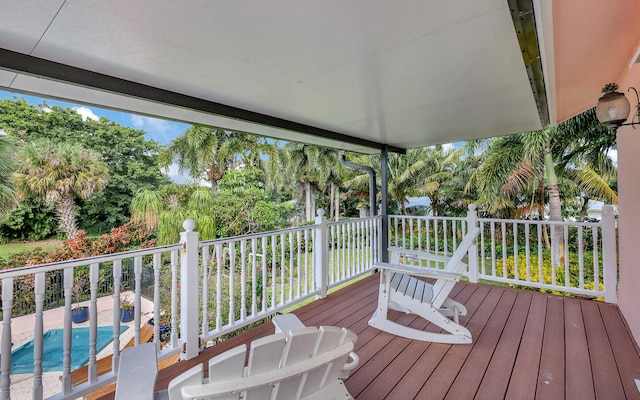 wooden deck featuring a fenced in pool