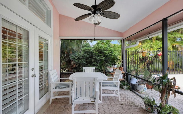 sunroom featuring lofted ceiling and ceiling fan