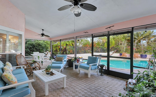 sunroom / solarium with ceiling fan, lofted ceiling, and plenty of natural light