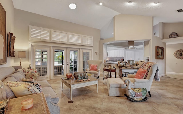 tiled living room with high vaulted ceiling