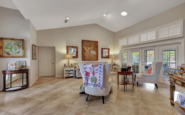 sitting room with high vaulted ceiling