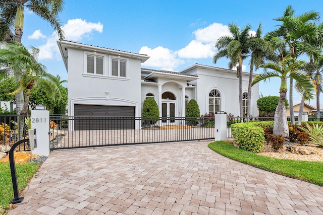 mediterranean / spanish-style home with a garage