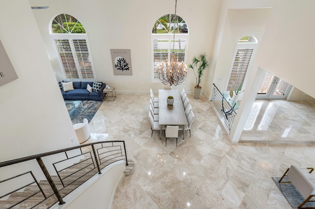 living room with a high ceiling and a notable chandelier