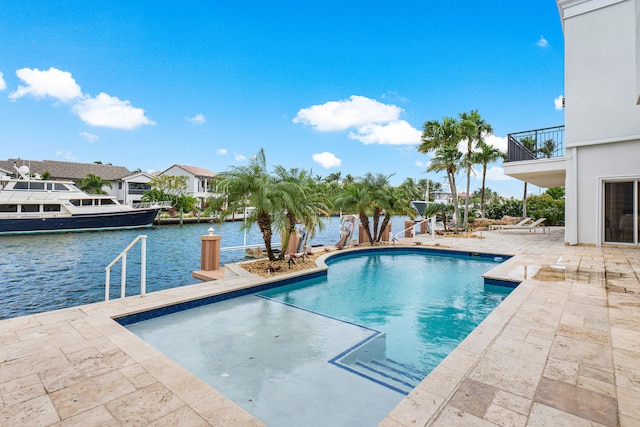 view of pool featuring a patio and a water view