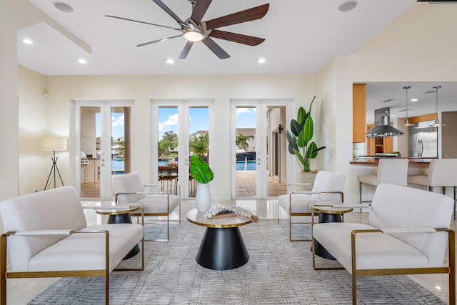 living room featuring ceiling fan and french doors