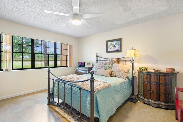 bedroom with a textured ceiling, carpet, and ceiling fan