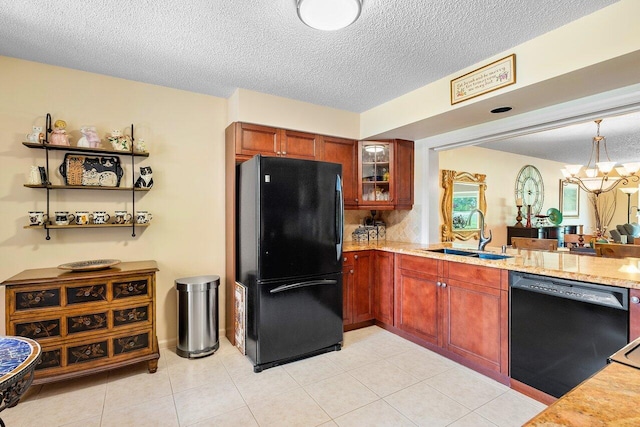 kitchen with black appliances, sink, a textured ceiling, decorative light fixtures, and a notable chandelier