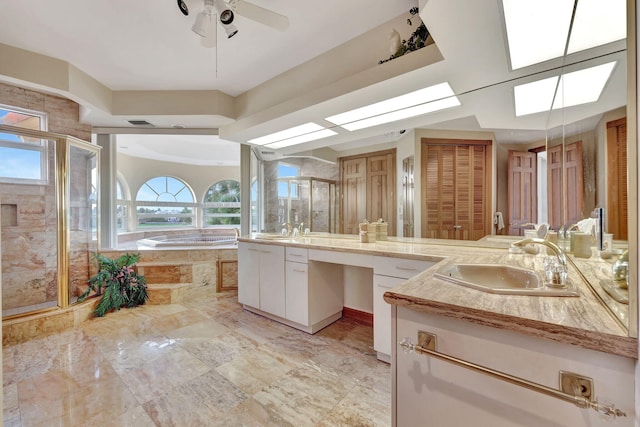 bathroom with a wealth of natural light, vanity, independent shower and bath, and ceiling fan