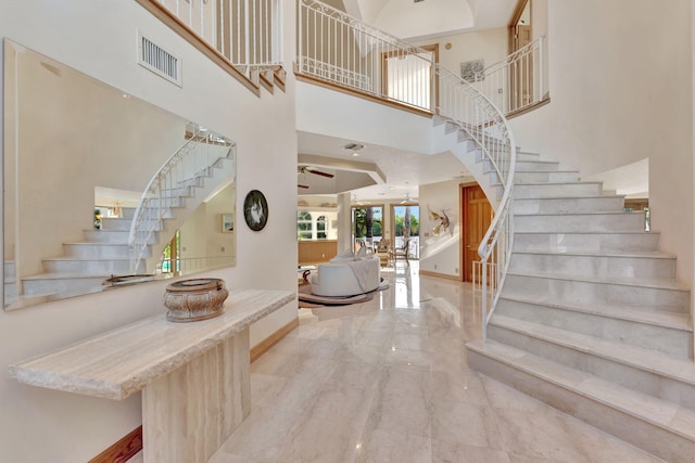 entrance foyer with a towering ceiling and ceiling fan