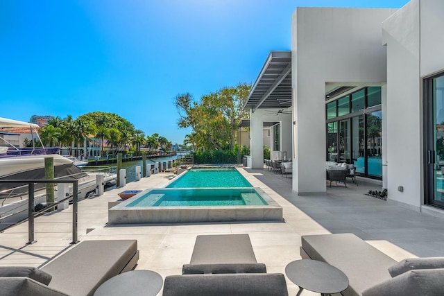 view of swimming pool with a patio area, a water view, ceiling fan, and an in ground hot tub