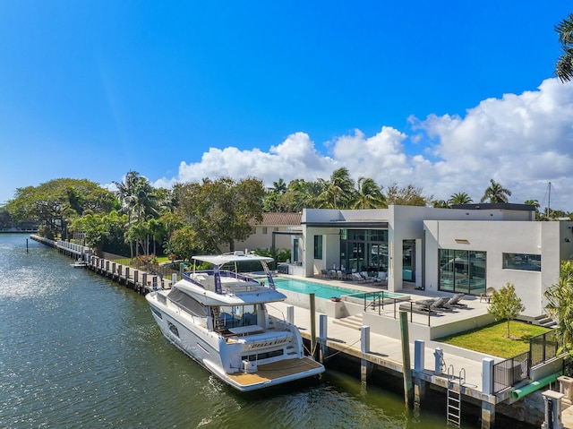 view of dock with a patio and a water view