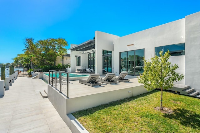 exterior space with a lawn, ceiling fan, and a patio area