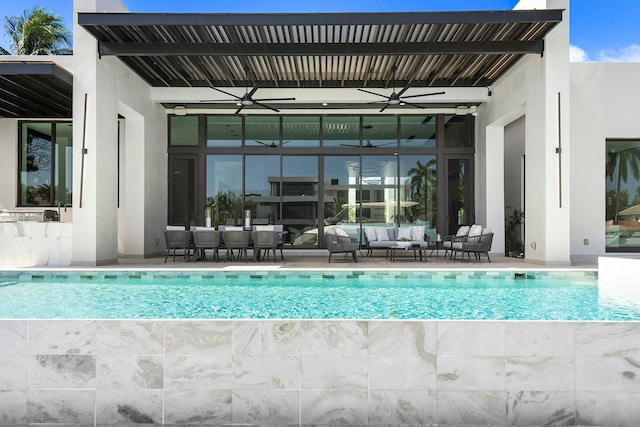 view of swimming pool featuring outdoor lounge area and ceiling fan