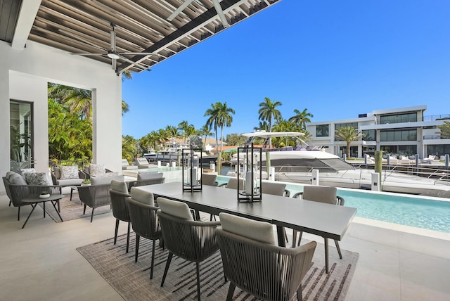 view of patio featuring ceiling fan and a community pool