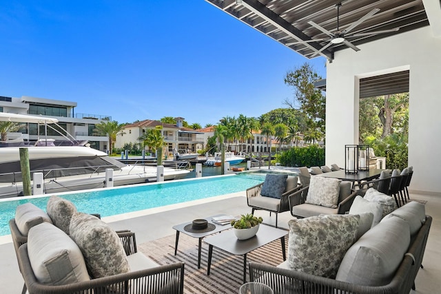 view of pool with a patio, an outdoor hangout area, and ceiling fan