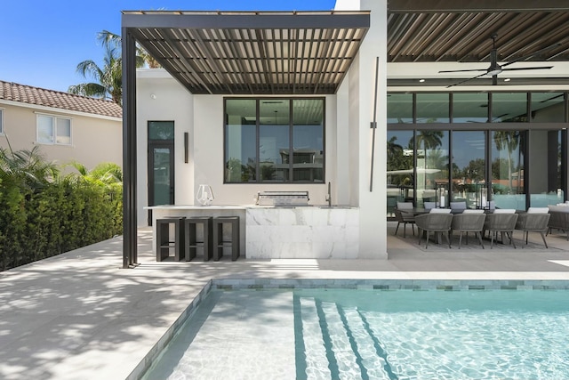 back of property featuring an outdoor bar, ceiling fan, a patio area, and a pergola