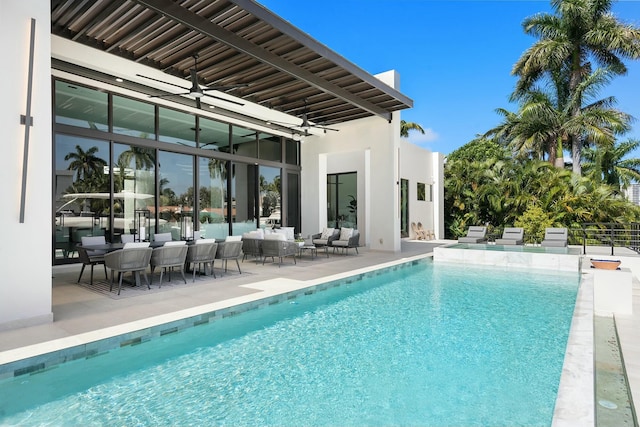 view of swimming pool with a patio, an outdoor hangout area, and ceiling fan