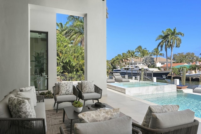 view of pool featuring an in ground hot tub, a water view, a patio area, and an outdoor hangout area