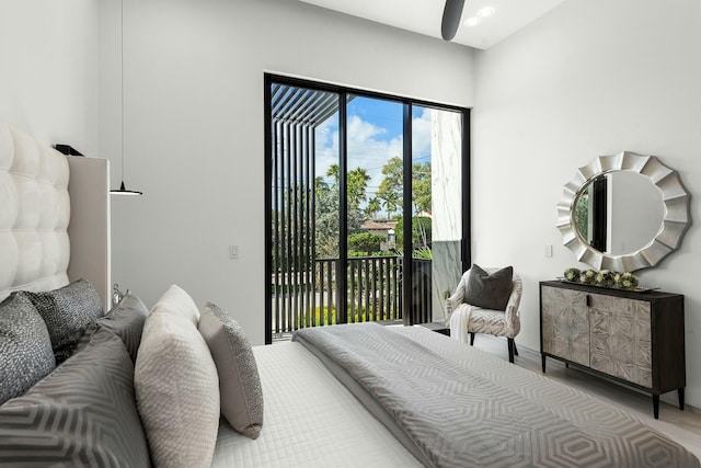 bedroom featuring access to outside and hardwood / wood-style floors