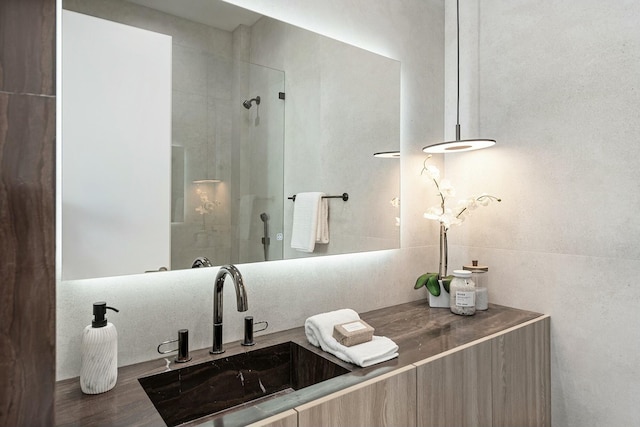 bathroom with vanity and a shower