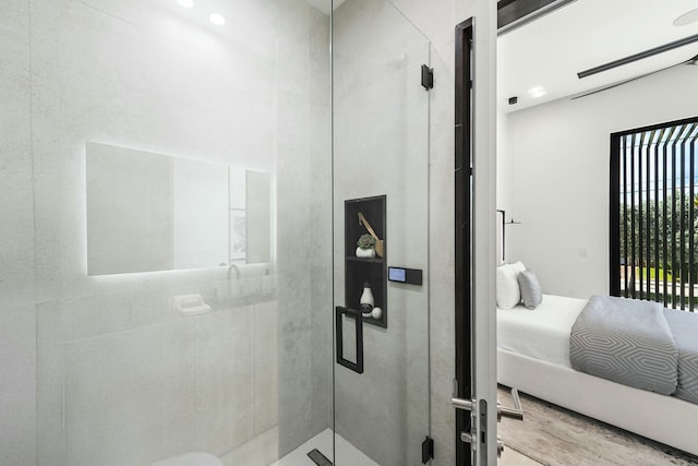 bathroom featuring a shower with door