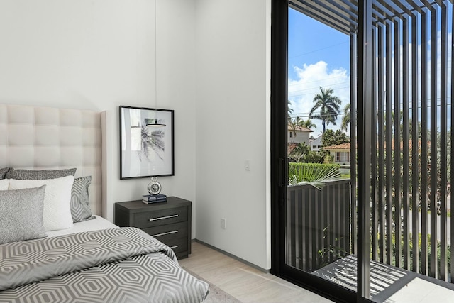 bedroom with light hardwood / wood-style flooring and access to exterior